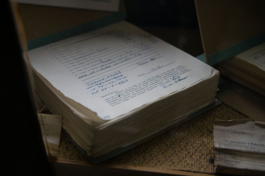 A thick stack of signed operational forms with handwritten identifiers, calculations, and authorizations.